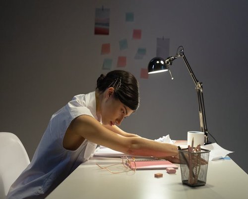 Office worker stretching hands slightly at desk